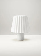Vinlume white textured cylinder bottle lamp with pleated shade, ideal for ambient lighting.